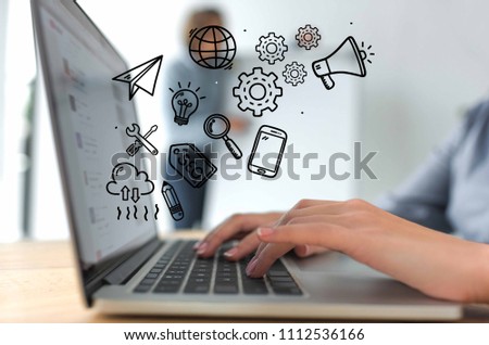 Cropped image of businesswoman working with laptop, hand-drawn business icons