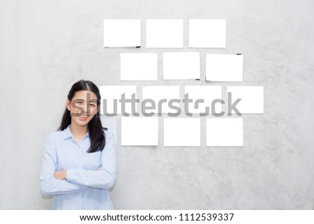 Beautiful of portrait asian young woman standing with picture gallery copy space on wall texture cement background.