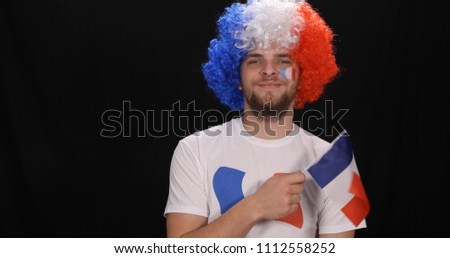 Happy Handsome French Supporter Man Waving a National France Flag Enjoy Victory of his Favourite Football Team in International Sport Event Competition