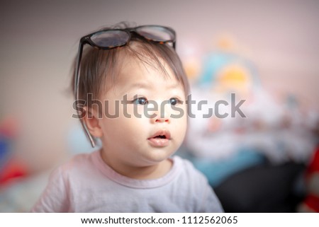 1 year old Asia baby girl playing glasses 