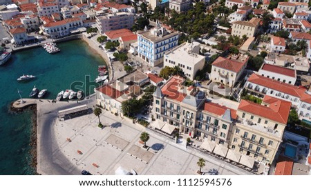 Aerial drone bird's eye view photo of picturesque landmark hotel near small port in historic and traditional island of Spetses, Saronic Gulf, Greece
