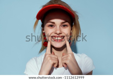beautiful smile of a young woman in a cap                               