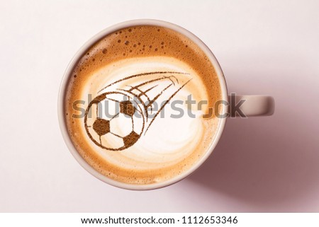 Coffee cappuccino in a cup for breakfast for a football fan Royalty-Free Stock Photo #1112653346