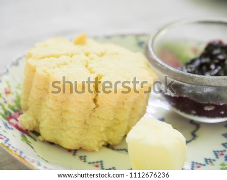 Bangkok, Thailand - Sep 13, 2014 : bear shape scone with butter and raspberry jam on colour plate