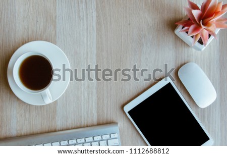 tablet and keyboard with coffee cup  on wooden table background
