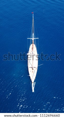 Aerial photo of sail boat docked in deep blue mediterranean sea
