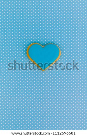Heart shaped cookie on colored background