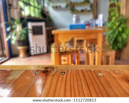 Wood empty table in front of blurred of inside cafe background