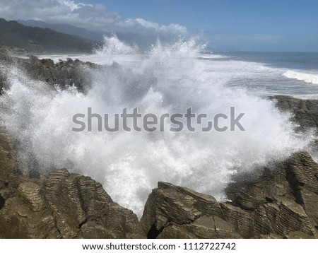 Water splash through a blowhole at pancakes rock west coast New Zealand.