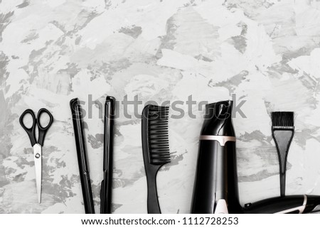 hair dryer, scissors, comb, brush, on a gray background, everything you need for a beautiful haircut and styling
