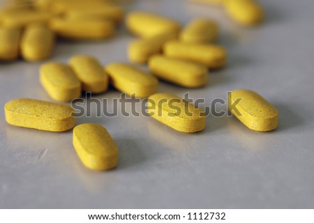 Tablets of B-complex vitamins scattered on a table Royalty-Free Stock Photo #1112732
