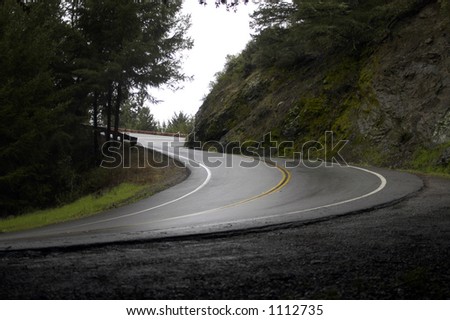 A steep corner on a wet winding road Royalty-Free Stock Photo #1112735