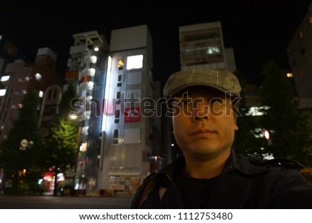 a man standing at street of akihabara in tokyo, japan
