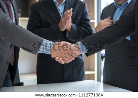 Group of confident business partnership shaking hands during a meeting in office,success,dealing,Greeting and partner concept. Discussing together startup Idea.Working online project.