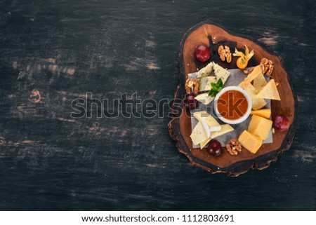 Assorted cheeses. Cheese plate. On a wooden background. Top view. Copy space.