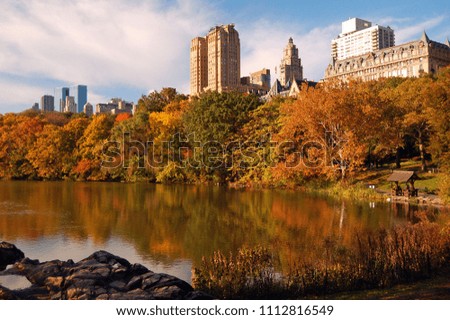 Brilliant Autumn colors in New York's Central Park contrast with the skyline behind the foliage