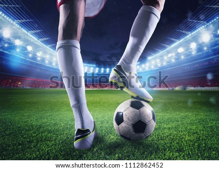 Soccer player with soccerball at the stadium ready for the match