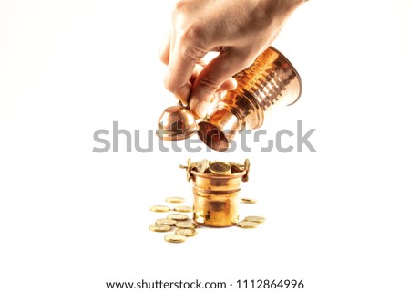 Coins stacked on each other in different positions.  Coin concept in copper bucket