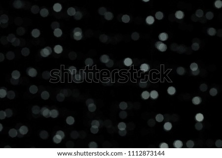 abstract dark background and white glare bokeh concept with empty space for copy or text