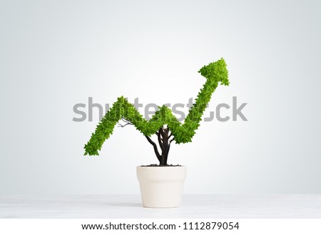 Small plant in pot shaped like growing graph Royalty-Free Stock Photo #1112879054