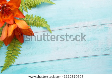 Flowers on a wooden background. Lily flowers. A gentle summer background. Celebratory background.