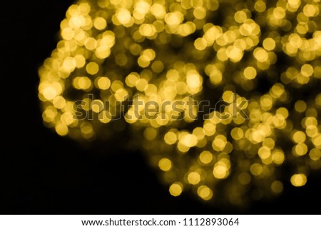 Abstract yellow and gold bokeh on black background