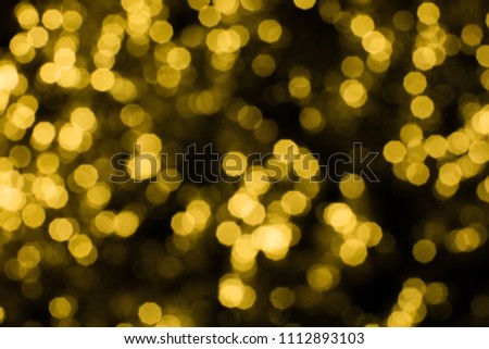 Abstract yellow and gold bokeh on black background