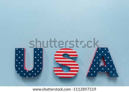 Painted USA sign with white, red and blue on blue background.