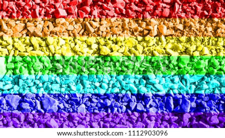 Nature sea pebbles background colored in the lgbt pride flag in vivid rainbow colors