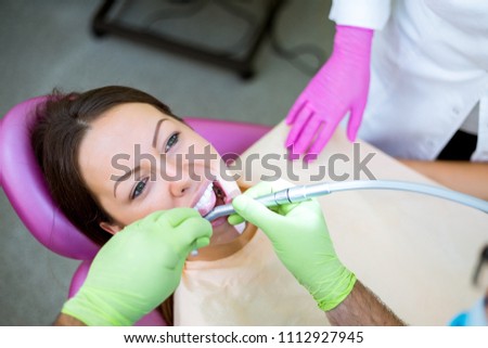 Dentist check up and repair tooth of young girl