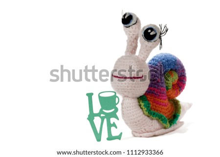 Crochet rainbow snail by sign LOVE, on white background. Amigurumi. Handmade