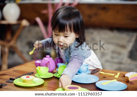 baby girl pretend play food toy Royalty-Free Stock Photo #1112960357