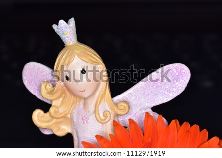 Beautiful Angel in dark time with orange flower ...Every girls dreams of being an angel.
