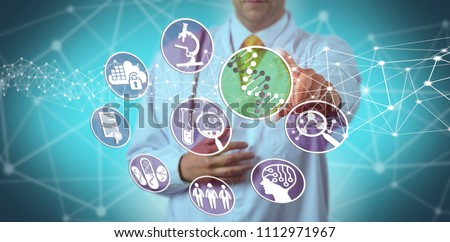 Unrecognizable male scientist using a pharmacogenomics platform in drug discovery. Concept for pharmaceuticals, bioinformatics, pharmacogenetics, DNA, biochemistry, pharmacology, genetic makeup. Royalty-Free Stock Photo #1112971967