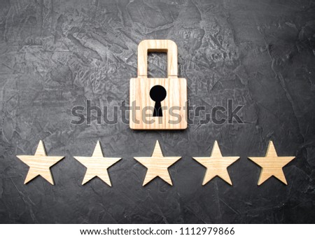 A wooden padlock and five stars. Security, security of users and business. Internet security, antivirus, data protection. Alarms of home, car and business. The concept of property protection.