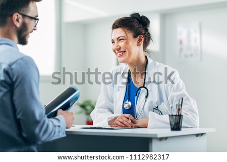 Doctor and patient sitting in doctor's office Royalty-Free Stock Photo #1112982317