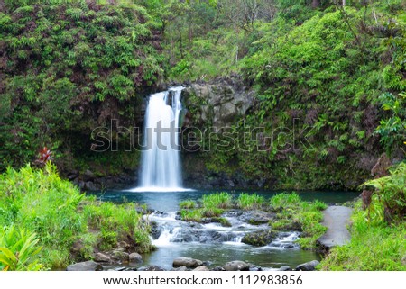 Pua'a Ka'a Fall, a waterfall, cascades into a pool, on the island of Maui Hawaii on the highway to Hana