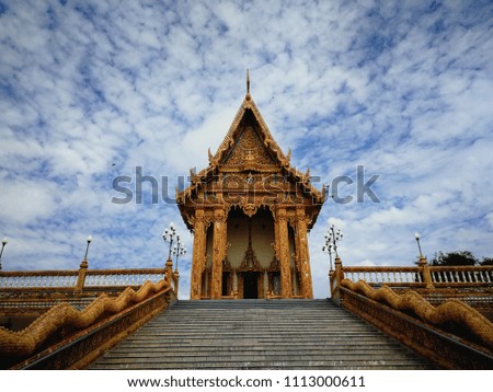 Thai pavilion at the temple with gold Naga Staircase and blue sky