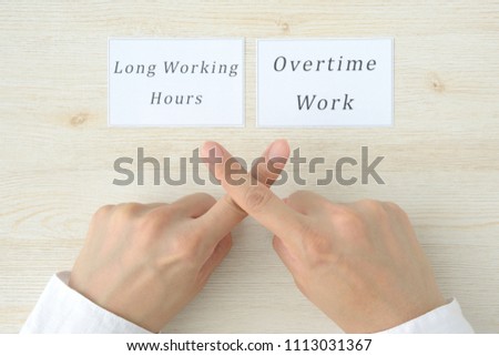 Hand cross mark against long working hours and overtime work