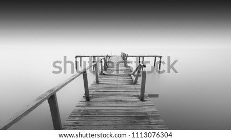 Amazing old abandon wooden jetty in minimalist black and white fine art photography at Teluk Tempoyak, Penang. (blurry soft focus noise grain visible full resolution) Nature composition