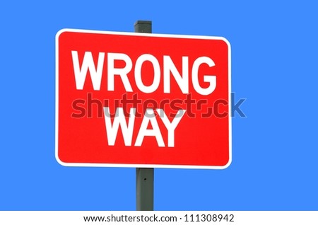wrong way sign isolated against a blue background