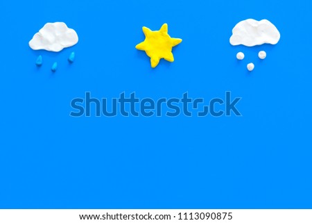 Clear, rainy, snow weather icons on blue background top view copy space