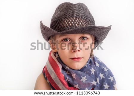 Cute boy in american flag scarf, black hat and jeans on white background - memorial day theme and 4th of July Independence day postcard
