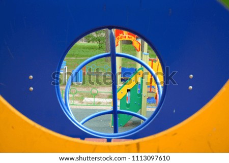 Elements of a children's playground with a round window.