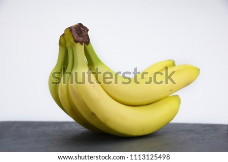 Bunch bananas on grey stone slate table