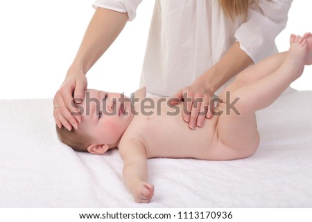 mom doing massage to baby on white background