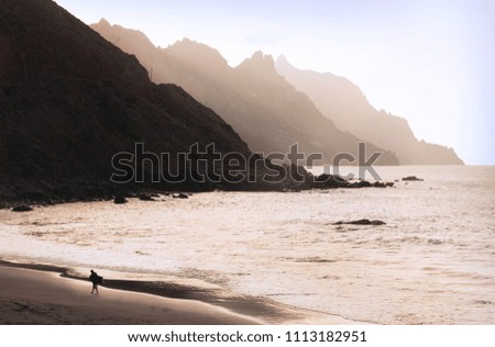 Sunset at a beach close to the cliffs of the canary islands 