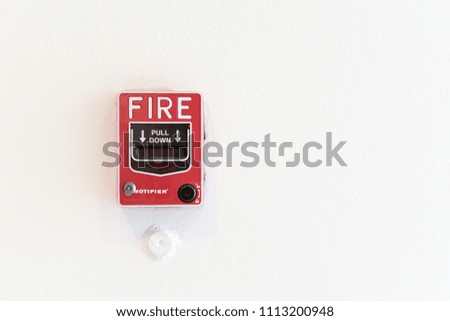 red fire alarm on the white wall with copy space
