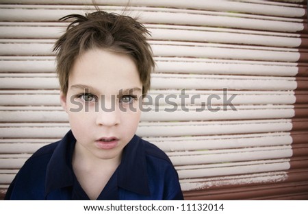 Young Boy with a Blank Stare and Green Eyes