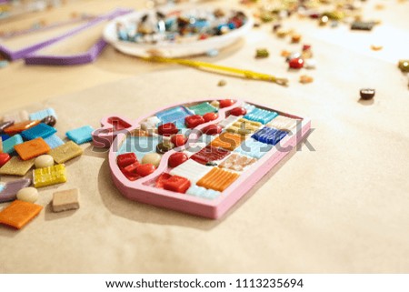The mosaic puzzle art for kids, children's creative game. mosaic at table. Colorful multi-colored details close up. Creativity, children's development and learning concept